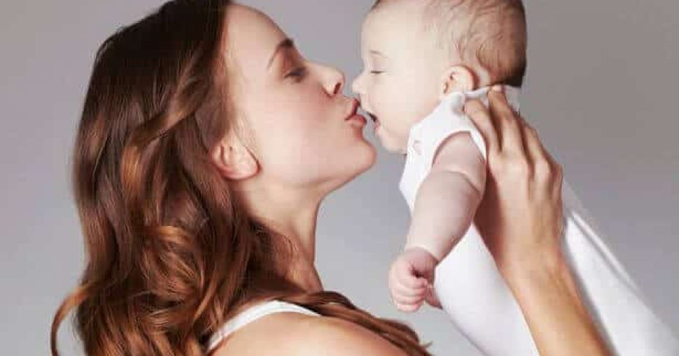 Mother-kissing-baby-daughter